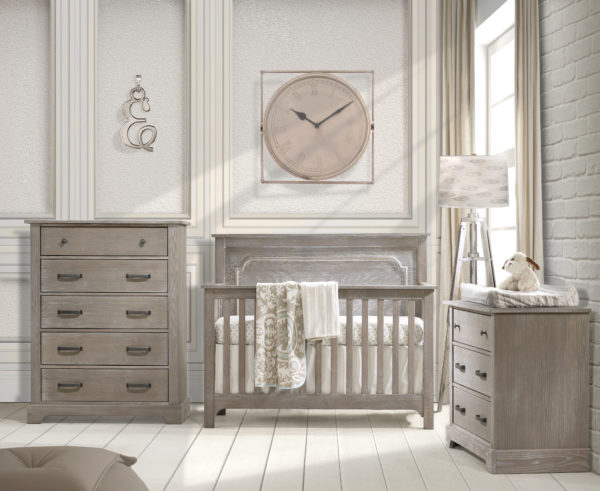Baby nursery with white brick wall, big beige clock and sugarcane wooden 3 drawer dresser, 5 drawer dresser and crib