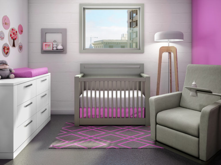 Baby nursery with white wall with a pink accent wall, grey sleek milano crib, a grey glider chiar and a white wooden double dresser