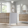 Beige nursery with white and natural oak wood crib and 3 drawer dresser