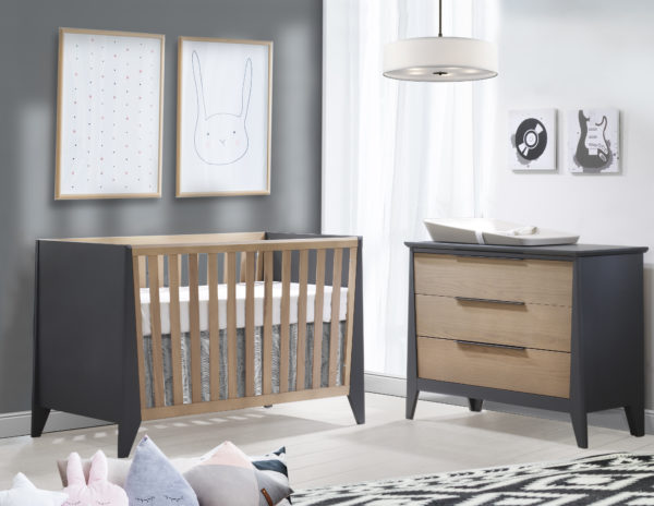 grey and white nursery with graphite and natural oak wood crib and 3 drawer dresser