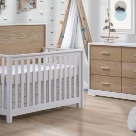 Light white nursery with cloud wallpaper and vibe collection furniture - Convertible Crib and 6 drawer double dresser in white and natural oak wood panels